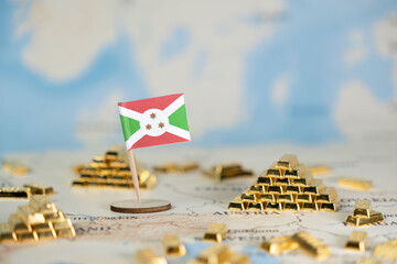 A small flag of Burundi placed on a world map, intricately arranged among numerous shimmering gold...