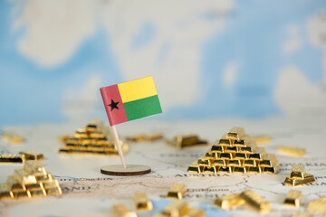 Guinea-Bissau flag with stacked gold bars on a world map, symbolizing national economic strength,...
