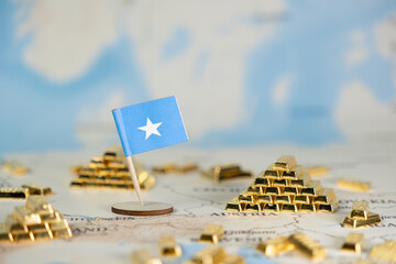Somalia flag and stacks of gold bars on a map, representing national economy, resource wealth, and...