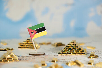 Mozambique flag on a world map with stacked gold bars, symbolizing national wealth, global resource...