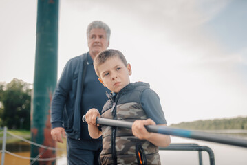 Grandfather and grandson rowing together in a lake: sharing precious moments