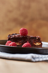 Piece of Chocolate Cake on a Plate. Rustic stone background. Copy space.