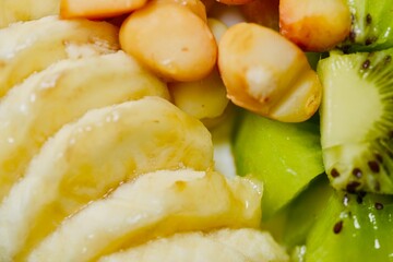 Smooth Greek yogurt served with a vibrant assortment of fruits and crunchy texture.