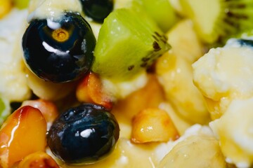 Nutritious combination of Greek yogurt with assorted fresh fruits and crunchy macadamias.