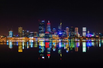 Nighttime panoramic view of perth city skyline with illuminated reflections in water
