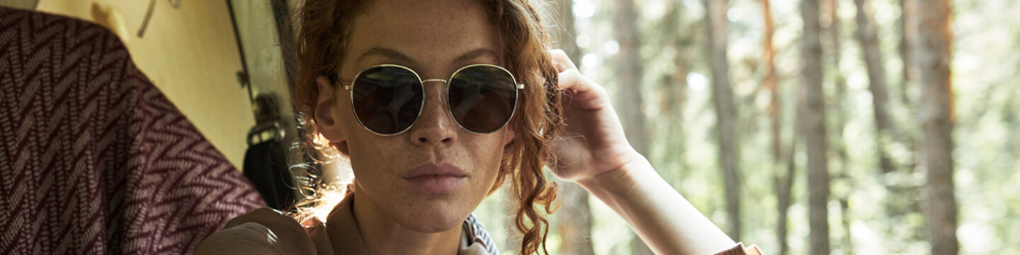 Young Womabn in Sunglasses sitting in Van Header