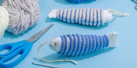 Handmade marine background. Crocheted sardine fishes, nautical style, traditional sea decor