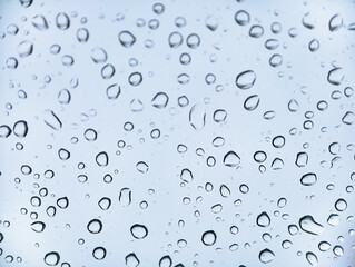 Raindrops on a window glass on a rainy day.