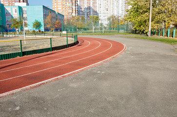 Red treadmill on sport field. Running track on the stadium