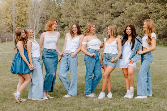 Gen z university students wearing denim and white outfits