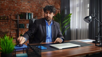 Obraz premium Professional Man in Office with Laptop and Documents