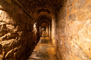 Obraz premium Illuminated Roman Cloaca (Sewer) Tunnel in Astorga. Castile and Leon, Spain