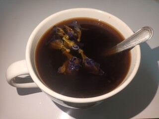 The white cup of black coffee.