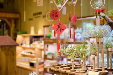 Taiwan May 30 2025: Festive Chinese New Year interior with red spring couplets, lucky knots and plants inside wood workshop, illustrating cultural holiday atmosphere