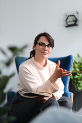 Young caucasian female therapist engaged in counseling session inside modern office