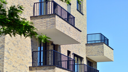 Eco architecture. Green tree and new residential building. Harmony of nature and modernity. Modern apartment building with new apartments in a green residential area.