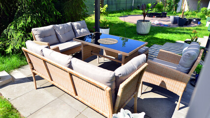 Modern aluminum pergola with stylish garden furniture in a beautiful garden.