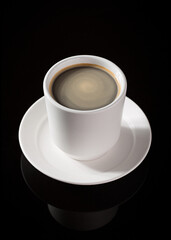 Cup of Black Coffee (Americano) in White Cup and Saucer on Black Reflective Surface