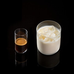 Espresso Shot with Iced Milky Drink on Black Reflective Surface