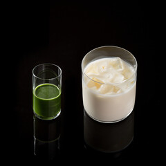 Healthy Green Juice Shot and Iced Milky Drink on Black Reflective Background