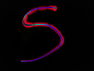 Glowing English letter S. On a black background with colored neon lines, a letter of the English alphabet is written by hand. The letter glows pink-red, creating a green-blue halo around it.