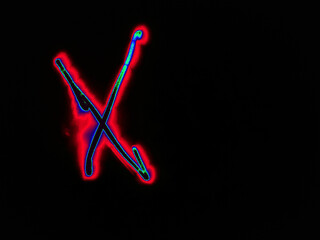 Glowing English letter X. On a black background with colored neon lines, a letter of the English alphabet is written by hand. The letter glows pink-red, creating a green-blue halo around it.