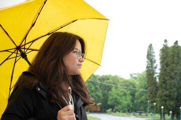 A young woman with a yellow umbrella	