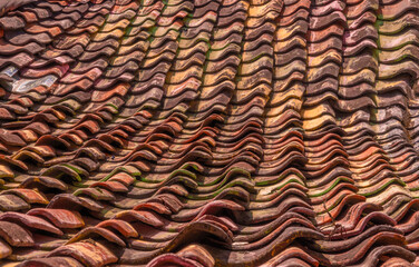 The beautiful pattern of red tiles on a house roof in a working class neighborhood of Surabaya, East Java, Indonesia