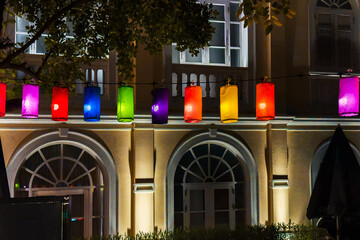 Colorful hanging lanterns create a vibrant atmosphere, illuminating the space with festive energy and cultural significance.