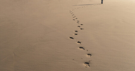 Footprints on sand, beach footstep, foot prints towards the horizon, symbolizing journey, seaside...