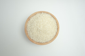 Rice in a wooden bowl isolated on white background