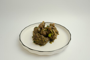 Rica-Rica lamb. A traditional dish from Manado, Indonesia, lamb is braised in a spicy paste and garnished with lemon basil.