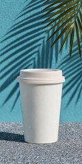 Obraz premium Mockup Disposable Coffee Cup on Teal Table Palm Leaf Shadow