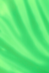 smooth artistic backdrop: close up of light green liquid paint brush strokes