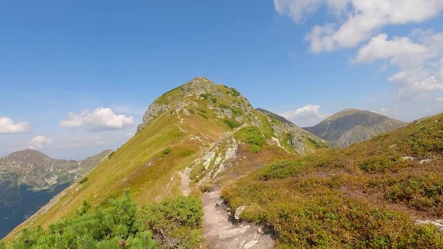 Hiking bellow Ostredok hill summit on Otrhance mountain ridge in Western Tatras mountains in Slovakia during beautiful summer day