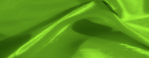 Blurred soft green fabric waves form gentle curves and abstract textures, radiating a peaceful...