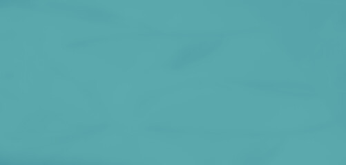 Blurred turquoise fabric with soft folds and a flowing texture, providing an artistic and serene aesthetic for creative backgrounds or elegant design projects.