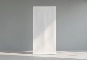 Blank roll-up banner mockup in minimal studio setting with natural light and shadows – perfect for advertising, branding, or promotional design templates.