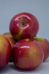 Close-up of juicy apples isolated on a light background – healthy eating and autumn fruits