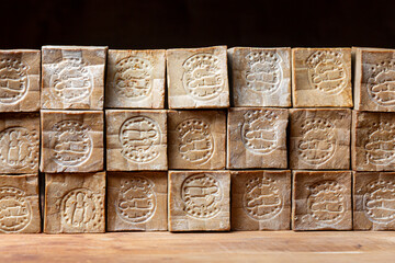 Rows of  of bars of aged and dry traditional aleppo organic laurel soap as a  background