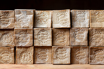 Rows of  of bars of aged and dry traditional aleppo organic laurel soap as a  background