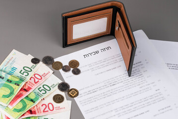 Rental or Residential Lease agreement contract in Hebrew and piggy bank. Short and long term rentals in Israel, housing searching crisis, signing lease agreement, and rising prices.