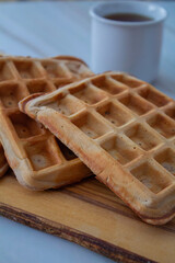 Freshly made waffles served with seasonal fruits and syrup – delicious homemade breakfast