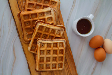 Freshly made waffles served with seasonal fruits and syrup &ndash; delicious homemade breakfast