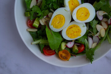 Fresh and vibrant homemade salad topped with sliced eggs and a light vinaigrette
