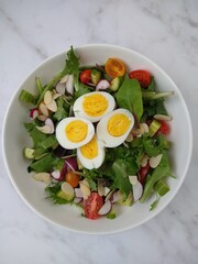 Fresh and vibrant homemade salad topped with sliced eggs and a light vinaigrette