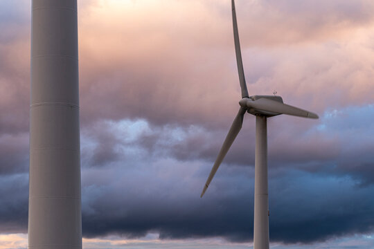 Wind turbines in Arag&oacute;n, Spain, at twilight, representing the commitment to renewable energy, climate action, and a sustainable future for all.