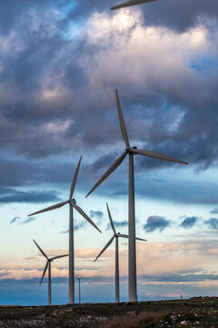 Clean energy scene with wind turbines in Arag&oacute;n, Spain, at dusk, emphasizing the beauty of renewable technology integrated with nature and the environment.