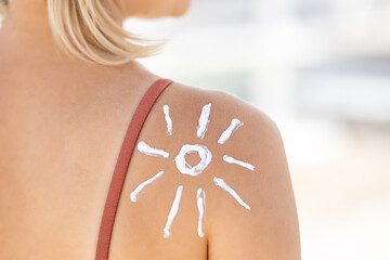 Applying sunscreen design on shoulder during sunny beach day