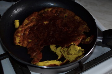 The omelet burnt on the frying pan.